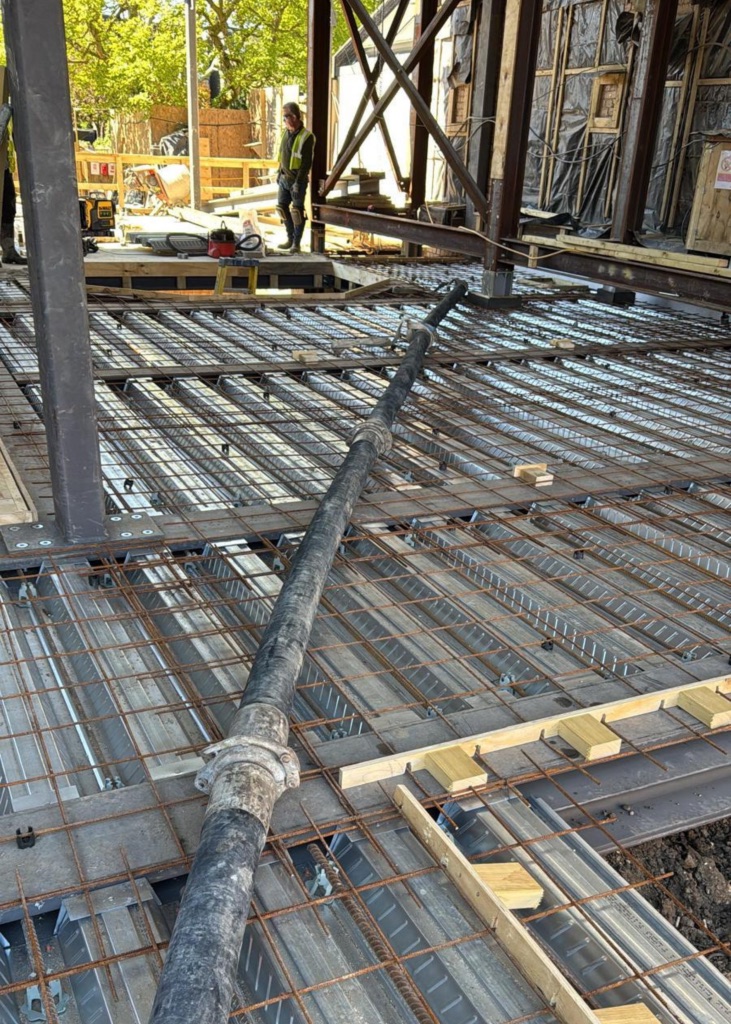A King Concrete Pumping line pump feeding concrete on site near Caterham
